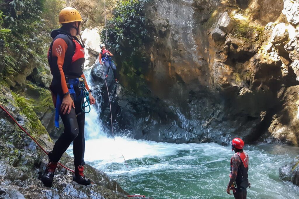 People on a canyoning tour in Queenstown, New Zealand