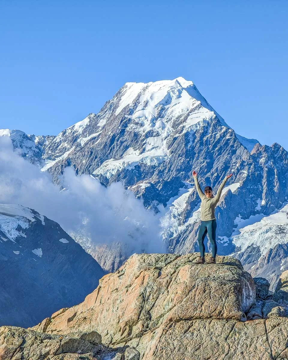 Bailey in the Muller Hut area stands on a rock with Mount Cook in the background