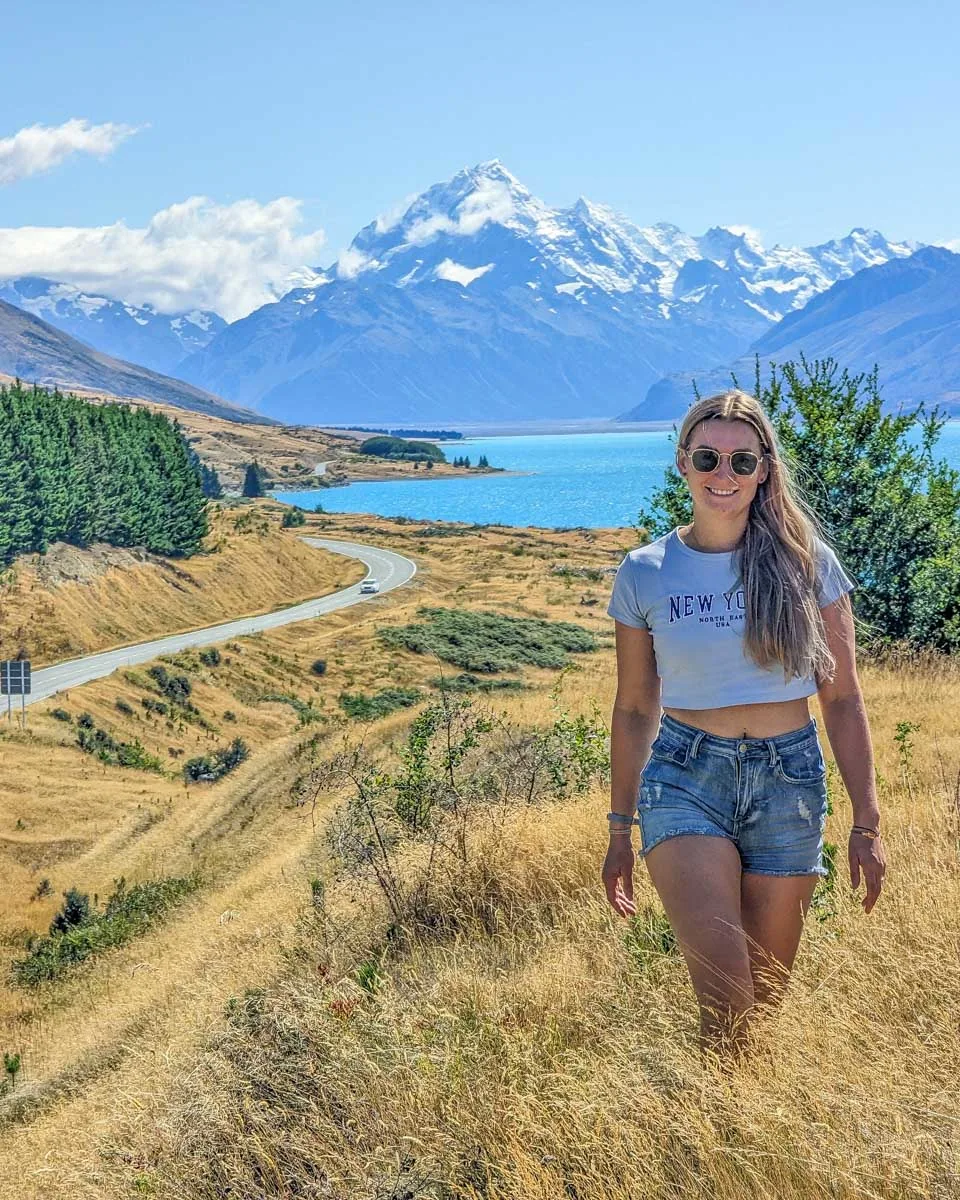 Bailey on Lake Pukaki Lookout on Mount Cook road with the famous view of the winding road with Mount Cook in the background