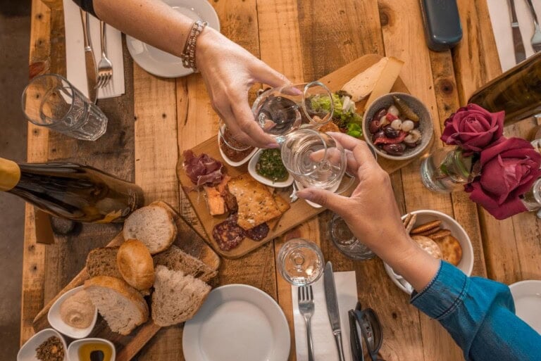 People cheers at a table at the Kinross winery in the Gibbston Valley near Queenstown