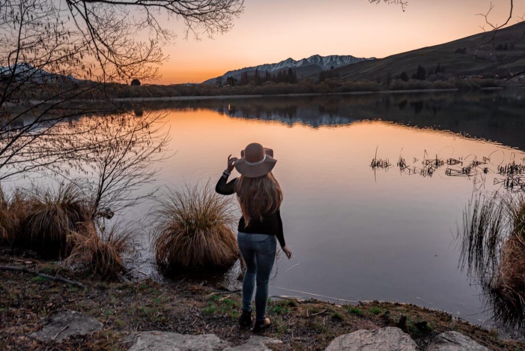 Lake hayes at sunset with a mountain backdrop