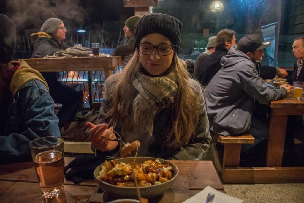 Bailey eats poutine and beer at Smithes Craft Beer house in Queenstown