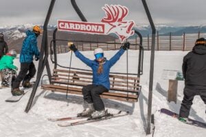 A lady sits on a seat at the top of Cardrona Ski Field