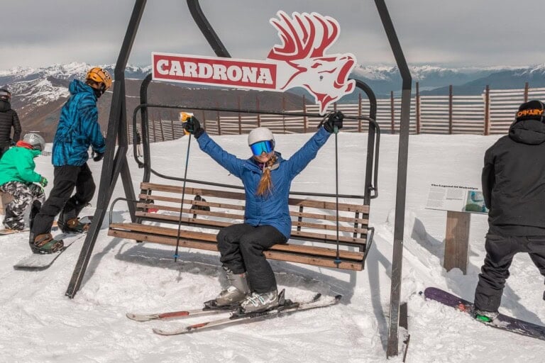 A lady sits on a seat at the top of Cardrona Ski Field