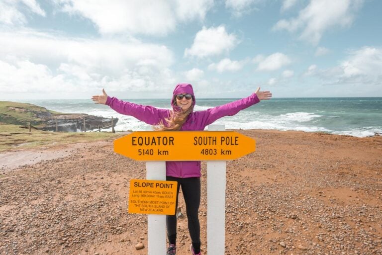 Bailey poses for a photo with the sign at Slop Point!