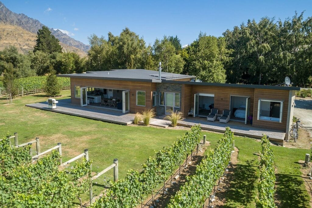 view of a beautiful airbnb near the shotiver river with a vineyard nearby in Queenstown, New Zealand