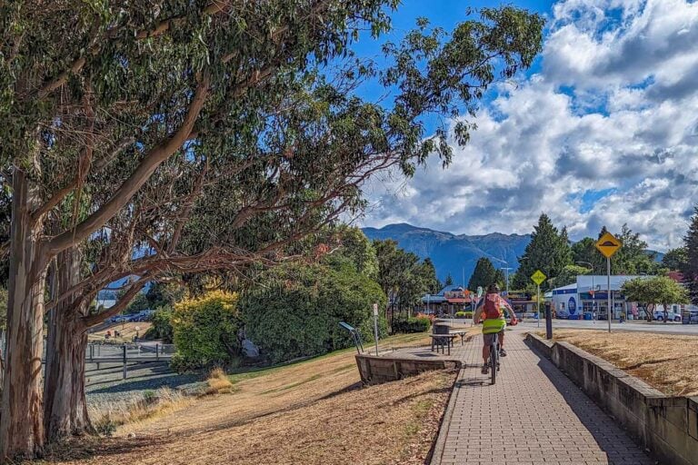 A person rides a bike along the Lake 2 Lake Trail in Te Anau, NZ