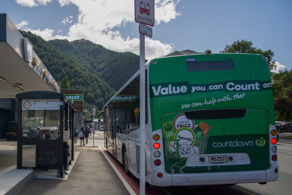 a bus parked at a bus stop in central Queenstown