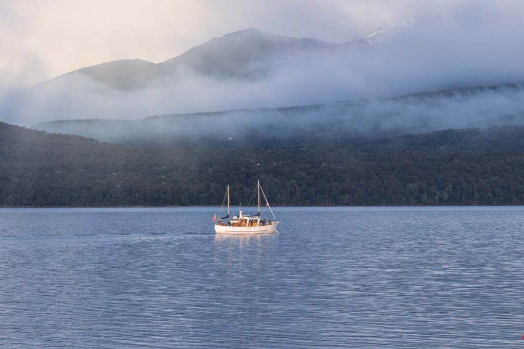 A boat cruises Lake Te Anau