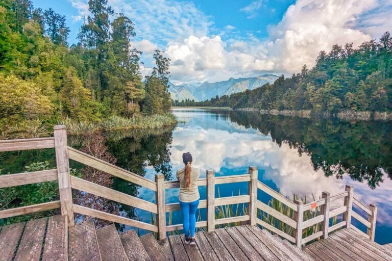 Bailey stands on the edge of Lake Matheson near Franz Josef, New Zealand