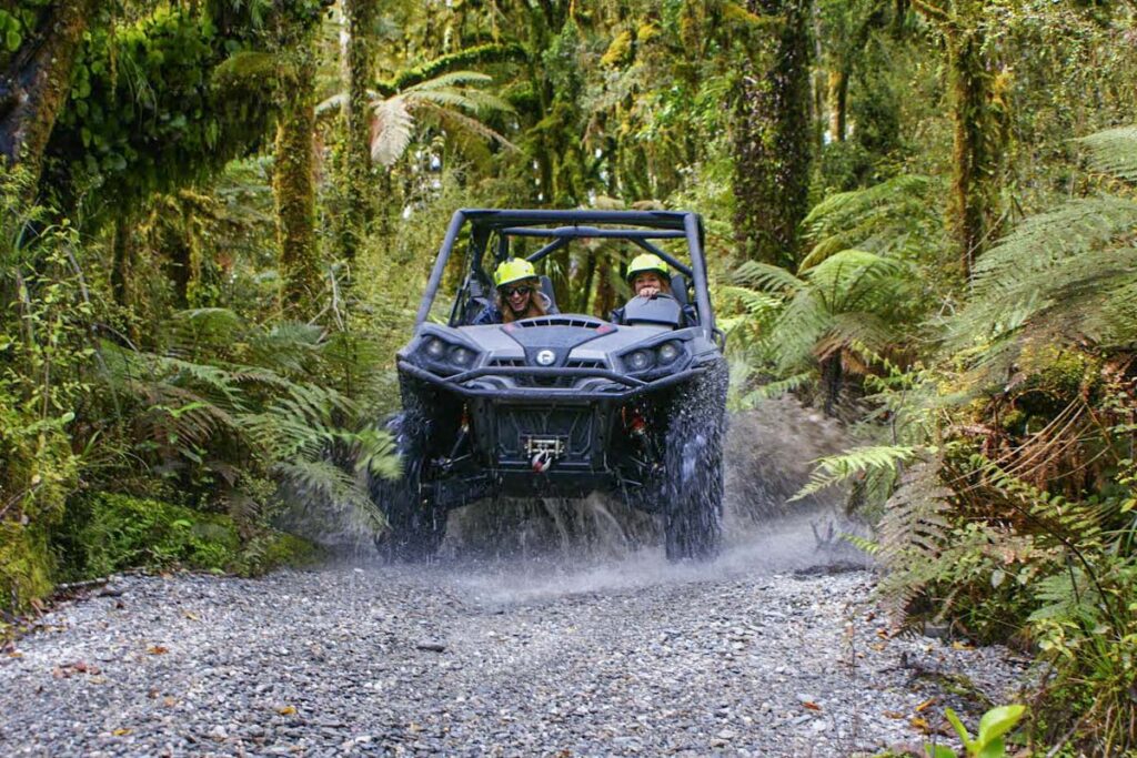 A quad bike rases through the jungle near Franz Josef