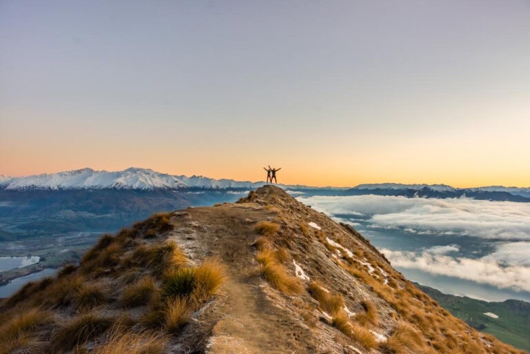 a couple at the top of Roys Peak in Wanaka