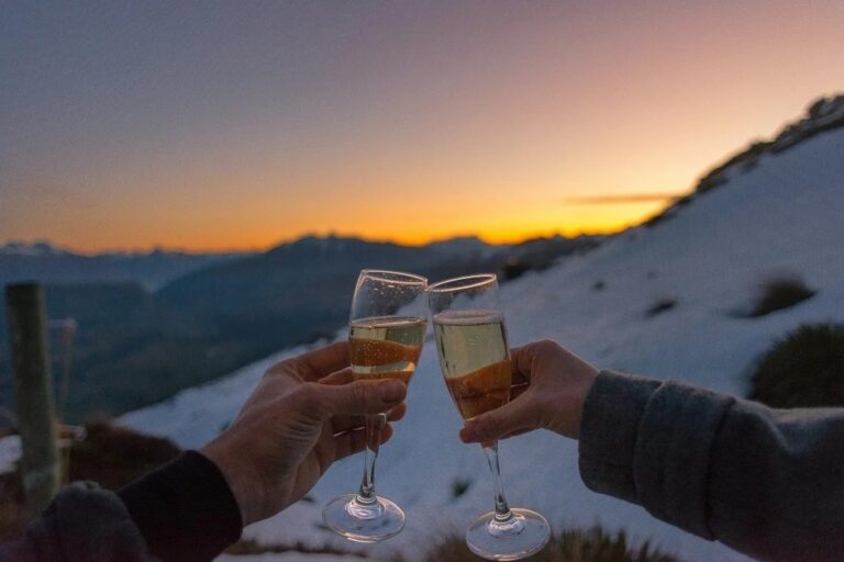 two people cheers champagne with mountain views in New Zeaand