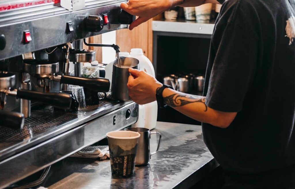 a barista making coffe at the Greedy Cow Cafe in Lake Tekapo