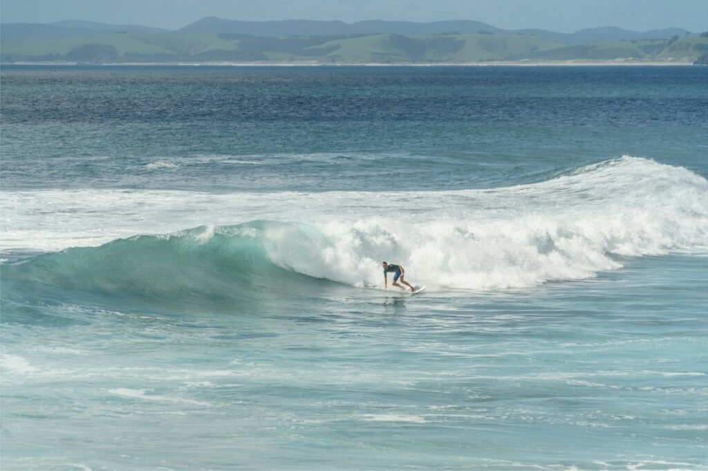 Surfer catching a wave in Kaikoura