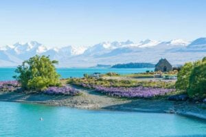 View of Lake Tekapo taken from town with views of the church