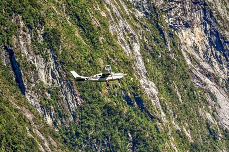 A plane fly's through Milford Sound, NZ