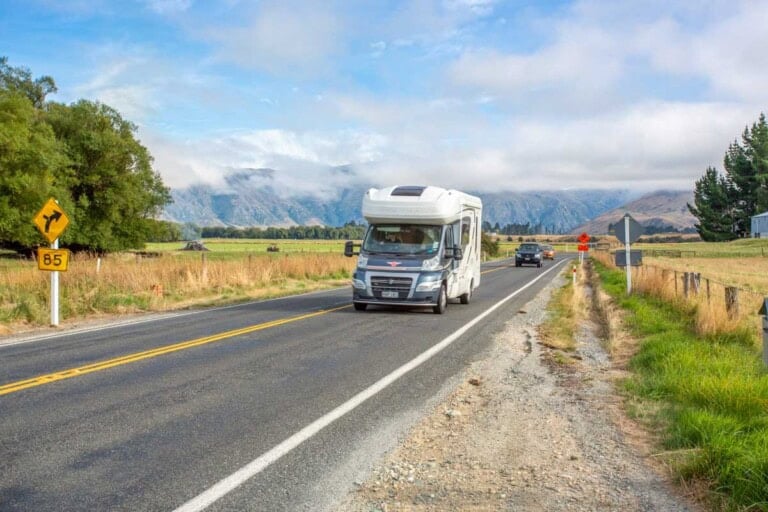 A motorhome drives along a road in New Zealand