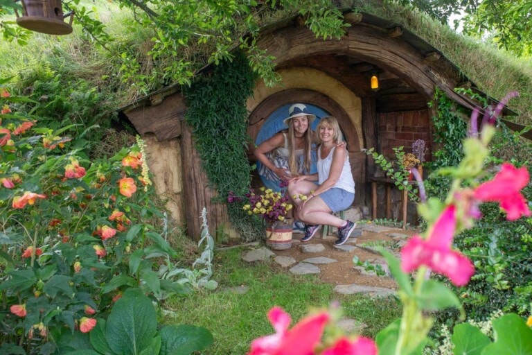 Bailey and her mum pose for a photo at a Hobbit Hole at Hobbiton, New Zealand