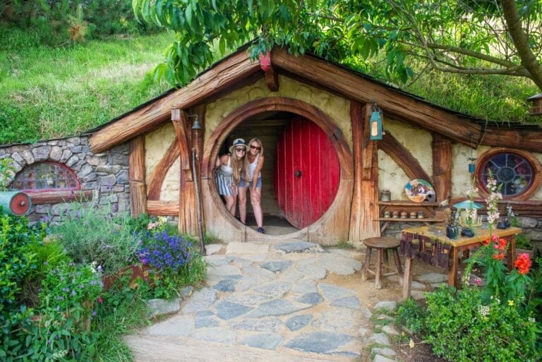 Bailey and her mum pose for a photo at the Hobbit hole you are allowed to enter at Hobbiton Movie Set in New Zealand