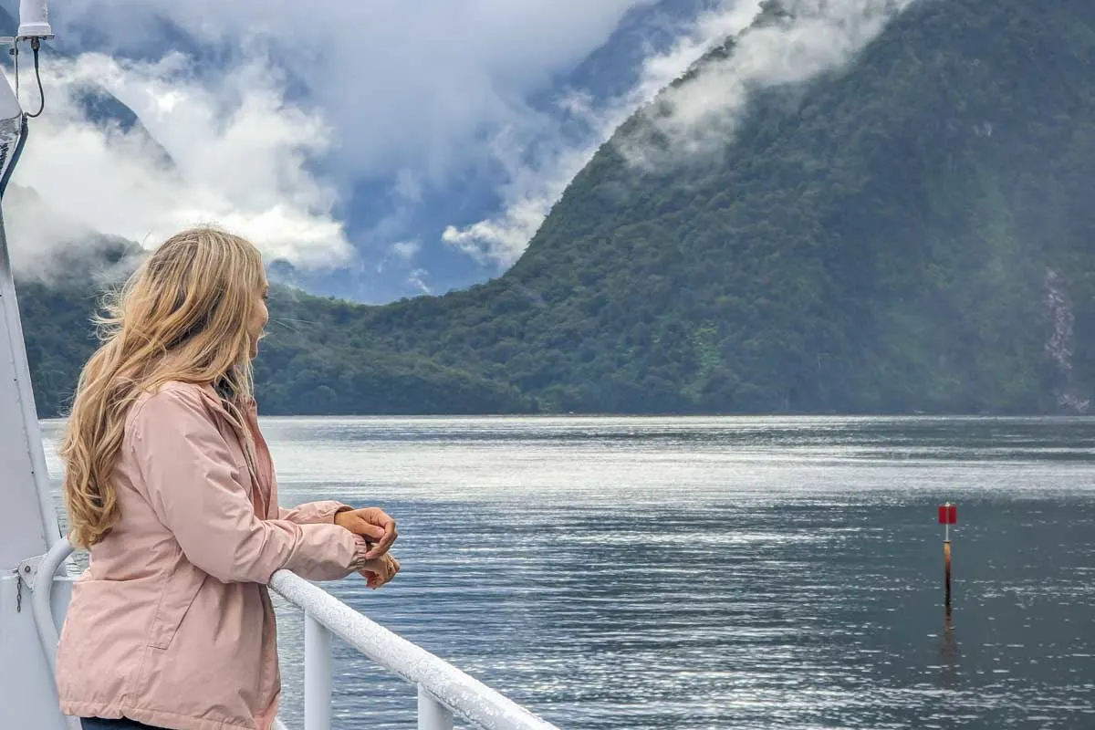 Bailey looks out on a cloudy Milford Sound on a day cruise