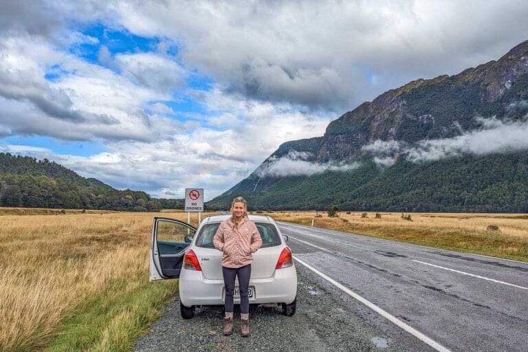 Bailey poses with her car in the Eglinton Valley on the way to Milford Sound