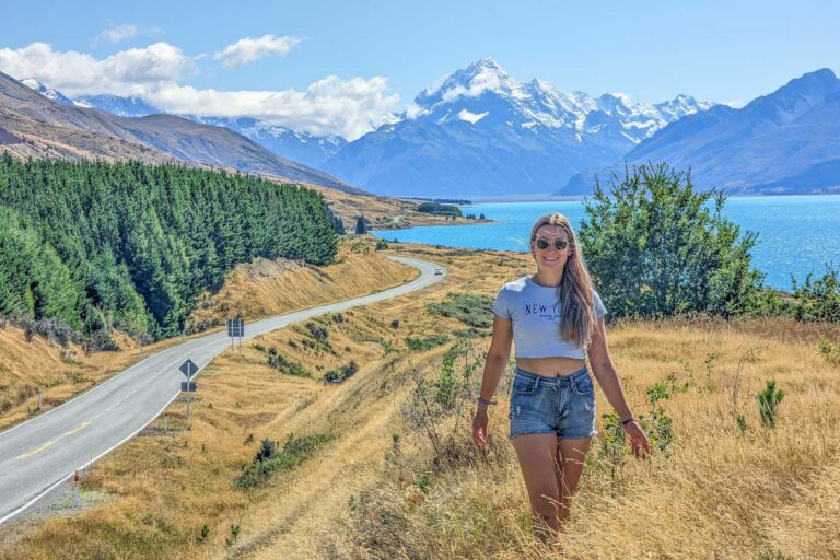 Bailey at the Mount Cook road viewpoint with the stunning highway in the background on a road trip in New Zealand