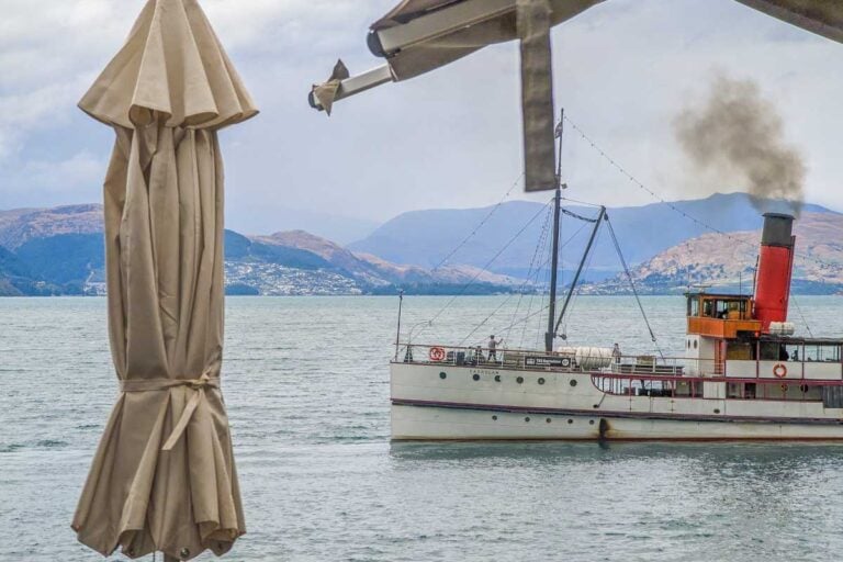 The TSS Earnslaw sails past the Walter Peak Farm