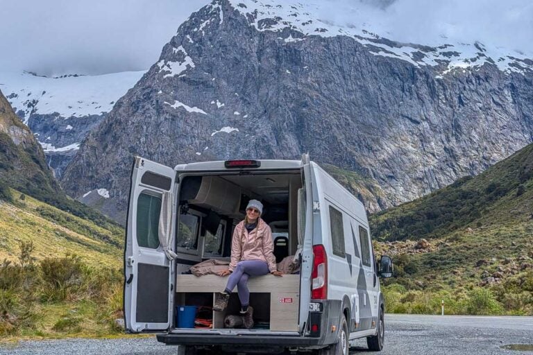 Bailey smiles near a mountain with a Star RV campervan in New Zealand