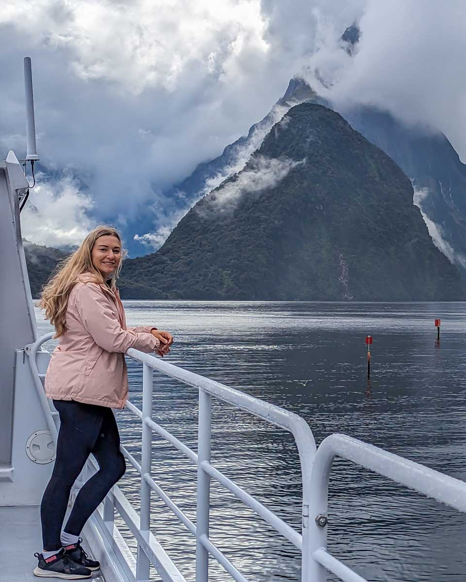 Bailey-enjoys-the-views-of-Milford-Sound-from-the-side-of-the-boat on a tour from Queenstown New Zealand