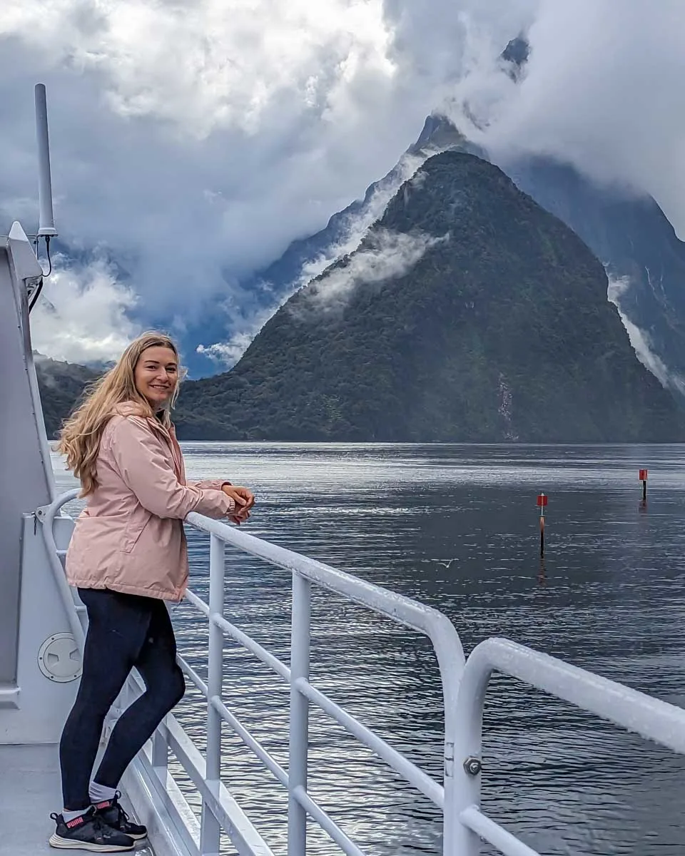 Bailey-enjoys-the-views-of-Milford-Sound-from-the-side-of-the-boat on a tour from Queenstown New Zealand