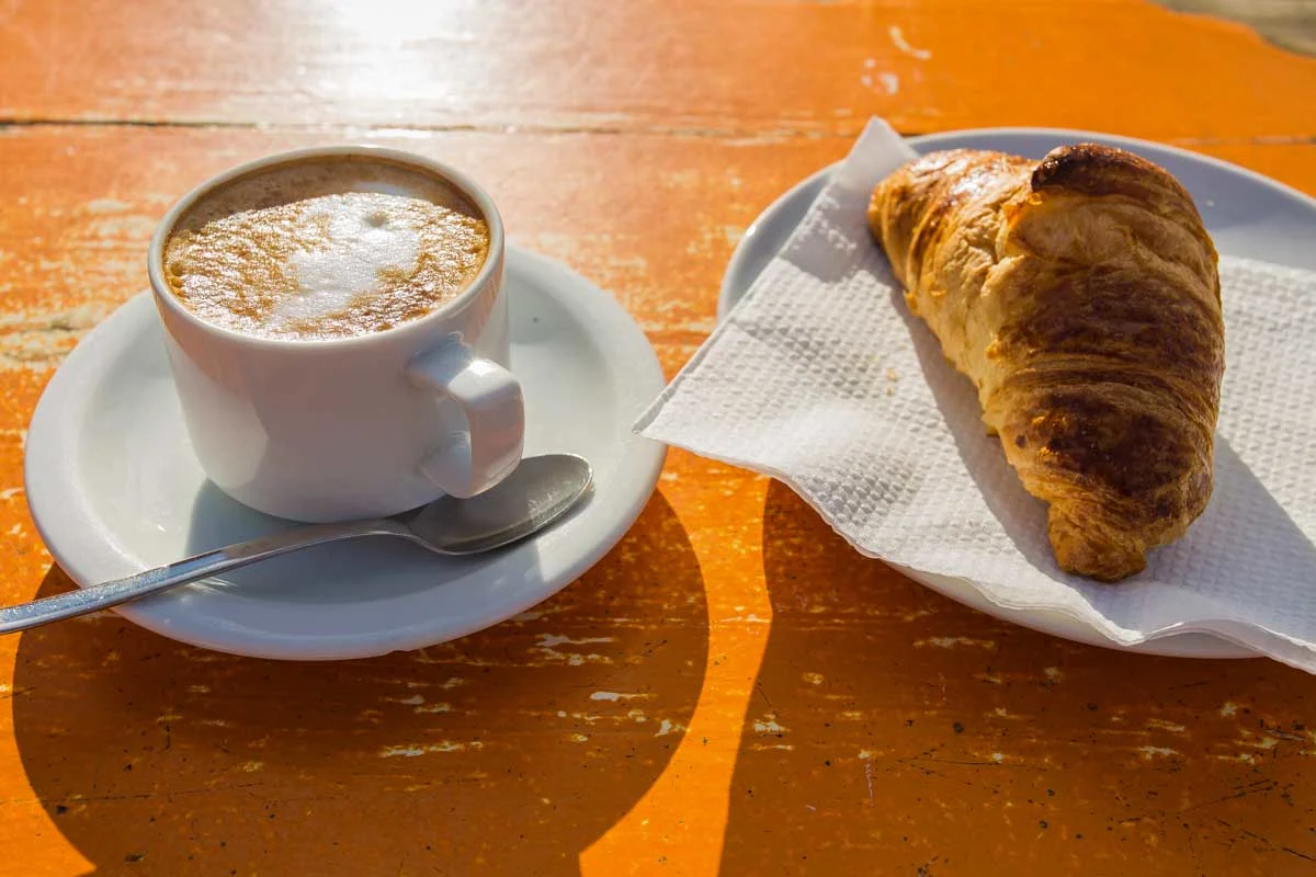 Cappuccino-with-croissant-eaten at Market Kitchen Cafe in Queenstown New Zealand